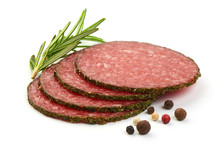 French Salami Slices With Herbs And Spices, Isolated On A White Background. Close-up