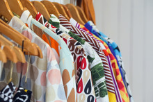 
Variety Of Colorful Shirts Hanging On The Wooden Hangers, Close Up 