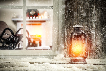 christmas lamp and snow decoration on window sill 