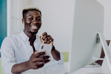 African american businessman making money witn hands up win at office