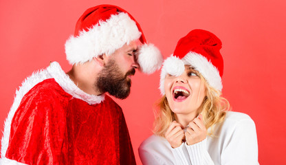 Poster - Man with beard and woman santa hat red background. Couple cheerful face celebrate christmas. Rent santa costume. Couple celebrate winter holiday christmas party. Christmas masquerade karnival concept