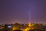 Fototapeta Tęcza - Lightning storm over city in purple light in jeddah al marwah