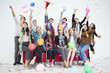 © iammotos - Group of happy young  people having fun on the red sofa celebrating together throwing colorful confetti  in party on white background. Asian friends . new year . funny