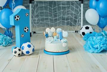 Festive background decoration for birthday with cake, letters saying one and blue balloons in studio, Boy Birthday .Cake Smash first year concept. birthday greetings.