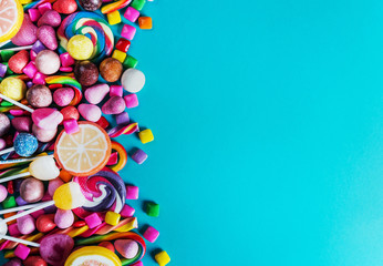  sweets, lollipop, chewing gum, candies etc on blue background