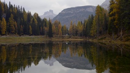 Wall Mural - Autumn landscape of Antorno lake with famous Dolomites mountain peak of Tre Cime di Lavaredo in background in Italian Dolomites.