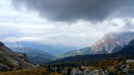 Wall Mural - Colorful scenic time-lapse shot of majestic Dolomites mountains in Italian Alps. Landscape timelapse footage of colorful trees and rocky mountains in the the Italian Dolomites during autumn time.