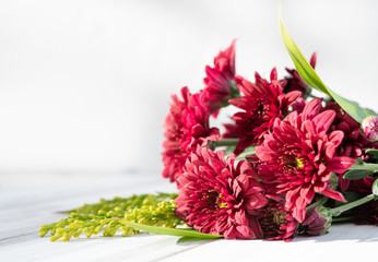 Beautiful red fresh chrysanthemum flowers boquet on white wooden background