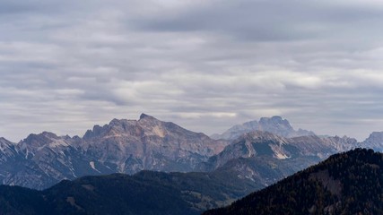 Wall Mural - Colorful scenic time-lapse shot of majestic Dolomites mountains in Italian Alps. Landscape timelapse footage of colorful trees and rocky mountains in the the Italian Dolomites during autumn time.