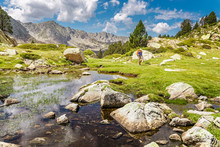Impressive View Of Pyrenees Landscape In Andorra, With Woman Hiker