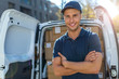 © pikselstock - Delivery man standing in front of his van