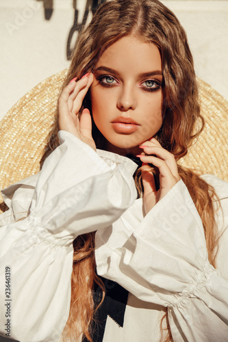 Beautiful Young Girl With Long Curly Hair Wears Elegant Straw Hat