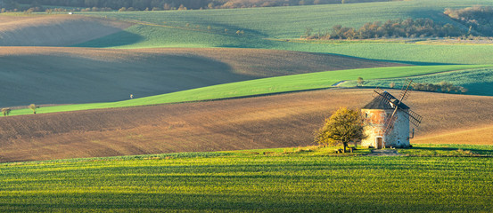 Panorama landscape with waves hills, autumn fields with mill.  South Moravia