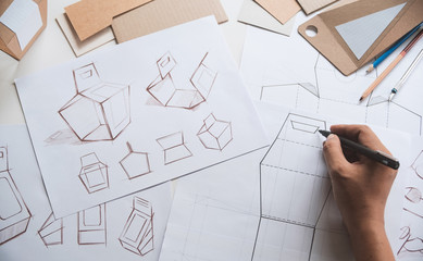 Wall Mural - Designer sketching drawing design Brown craft cardboard paper product eco packaging mockup box development template package branding Label . designer studio concept .