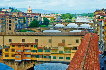 View of medieval stone bridge Ponte Vecchio and the Arno River in Florence, Tuscany, Italy. Florence is a popular tourist destination of Europe.