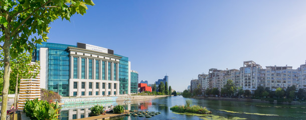 The modern National Library of Romania on the shoreline of Dambovita River on a sunny clear day, Bucharest, Romania