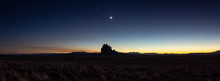 Dramatic Panoramic Landscape View Of A Dry Desert With A Mountain Peak In The Background During A Clear Night Sky After Sunset. Taken At Shiprock, New Mexico, United States.