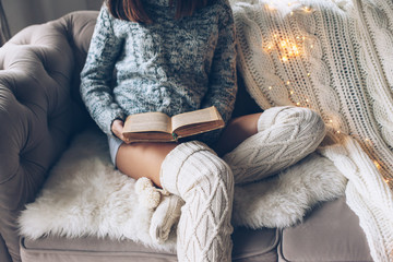 Wall Mural - Girl reading and relaxing on a couch