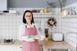 © MaaHoo Studio/Stocksy - Young asian female making Christmas cookie in kitchen