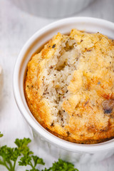 Wall Mural - Polenta with mushrooms in white ramekin bowl on wooden rustic table. Close up