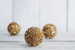 © Gabriel (Gabi) Bucataru/Stocksy - Sparkly golden Christmas tree decorations