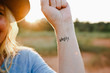 © Erin Drago Photography/Stocksy - Woman with ''worthy'' tattooed on her arm