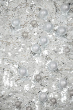 Silver Baubles Against Shiny Background