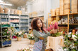 © Javier Díez/Stocksy - Charming worker of floral shop on job