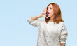 © Krakenimages.com - Young beautiful woman over isolated background wearing winter sweater shouting and screaming loud to side with hand on mouth. Communication concept.