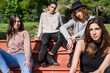 © Guille Faingold/Stocksy - Stylish girls on bench in park.