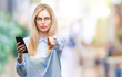 © Krakenimages.com - Young beautiful blonde business woman using smartphone over isolated background pointing with finger to the camera and to you, hand sign, positive and confident gesture from the front