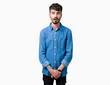 © Krakenimages.com - Young handsome man over isolated background afraid and shocked with surprise expression, fear and excited face.