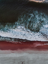 Aerial View Of A Red And White Sand Beach