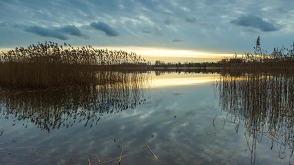 Wall Mural - 4k timelapse of beautiful lake after sunset with cloudy sky reflected in water. Beautiful Poland. 4096x2304