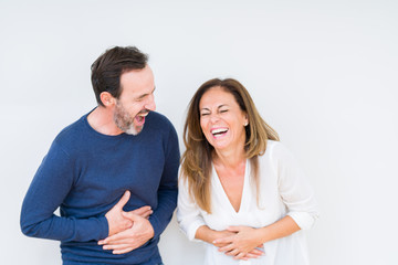 Wall Mural - Beautiful middle age couple in love over isolated background Smiling and laughing hard out loud because funny crazy joke. Happy expression.