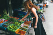 © Andrey Pavlov/Stocksy - Woman shopping for vegetables on market