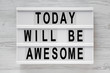 'Today will be awesome' words on lightbox over white wooden surface, top view. Overhead, flat lay, from above.