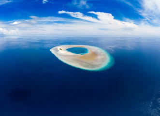 Wall Mural - Aerial idyllic atoll, scenic travel destination Maldives Polinesia. Blue lagoon and turquoise coral reef. Shot in Wakatobi National Park, Indonesia