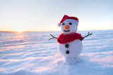 Fototapeta Na sufit - snowman on orange sunset background christmas santa