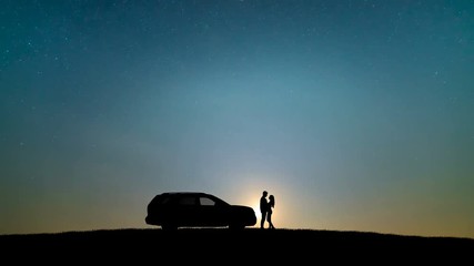Wall Mural - The couple standing near vehicle against the sunset. time lapse