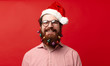 © Vulp - Portrait of cheerful bearded man with decorated christmas beard and wearing santa claus hat