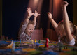 © oleg_ermak - Board game concept.Two little girls spend fun time at home playing board games. Board game field, many figures, two kid girls play in board game at home on dark blurred background