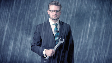 Wall Mural - Young handsome  man holding tool with raindrop graphic