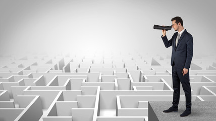 Wall Mural - businessman standing on maze and looking forward to the future concept