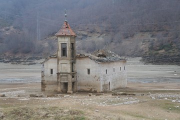 Wall Mural - The St Nicholas Church near Mavrovo lake in Macedonia. It was built in 1853 and submerged in the lake in 1953
