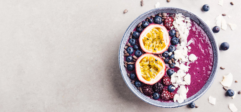 Smoothie acai bowl served in bowl on grey table