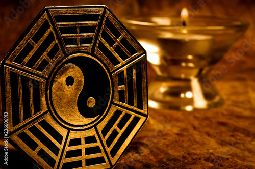 Fotografie, Obraz yin yang with i-ching symbols with candle in background