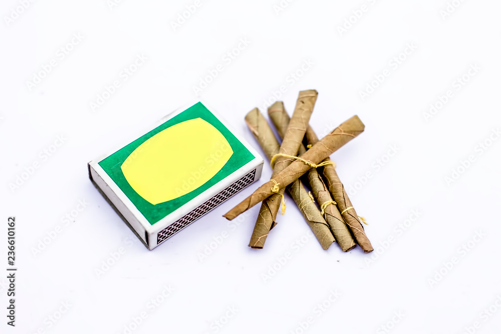 Close up of Mini cigar or mini cigarette or bidi or beedi isolated on white  with a matchbox. Stock Photo