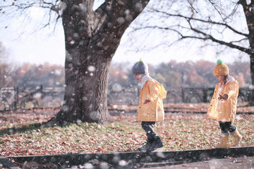 Wall Mural - Kids walk in the park first snow