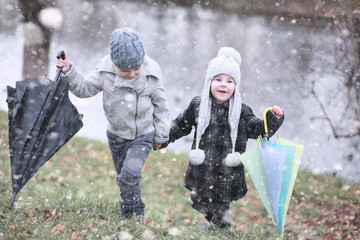 Wall Mural - Kids walk in the park first snow